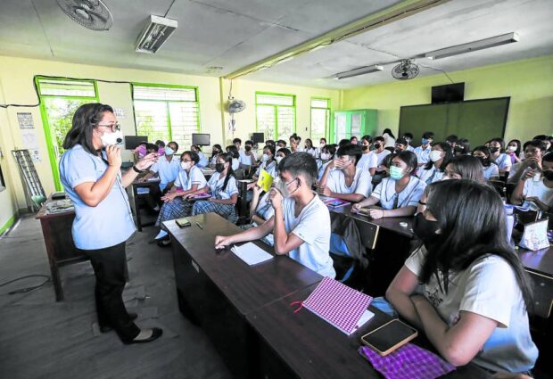 A teacher holds an in-person class for students of Navotas National High School in this photo taken in November 2022. The Department of Education is reviewing its K-12 curriculum as it aims to train more job-ready graduates. 