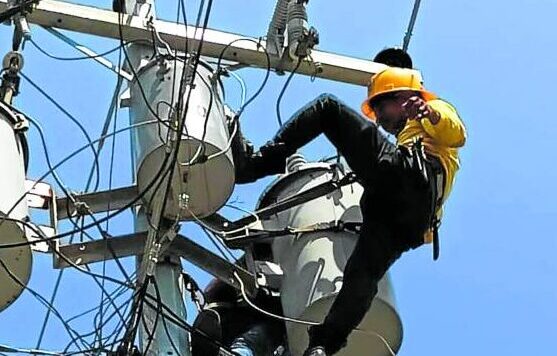 Linemen in Mamburao, Occidental Mindoro, inspect and repair power lines and transformers even as the province suffers from outages lasting several hours a day.