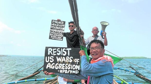 Fishers and their supporters sail alongthe coast of Masinloc town in Zambales 