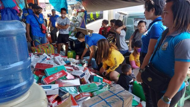 Government agents take inventory of the dozens of reams containing alleged illegal cigarettes that were confiscated during an operation at the Cogon public market in Cagayan de Oro on April 26. (Photo courtesy of the CIDG Cagayan de Oro field unit)