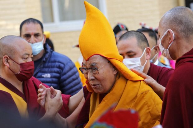(FILES) In this file photo taken on April 5, 2023, Tibetan spiritual leader Dalai Lama (C) arrives to attend a prayer at the Main Tibetan Temple in McLeod Ganj. (Photo by AFP)