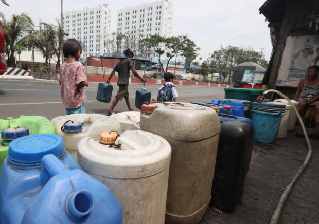 Residents of Bgy. 101 in Tondo, Manila line up their plastic containers to collect water as Maynilad Water Services Inc., announced daily water service interruptions across Metro Manila starting on March 28 and 29, 2023, to conserve water as the El Nino phenomenon looms. STORY: Store water, avoid dengue, DOH urges public