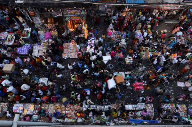 People shop at a crowded market ahead of Diwali, the Hindu festival of lights, in the old quarters of Delhi