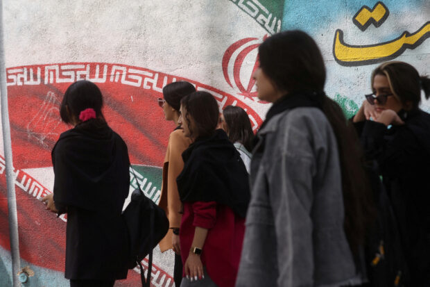 Iranian women walk in a street in Tehran