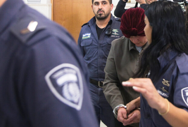 Malka Leifer, a former Australian school principal who is wanted in Australia on suspicion of sexually abusing students, walks in the corridor of the Jerusalem District Court accompanied by Israeli Prison Service guards, in Jerusalem