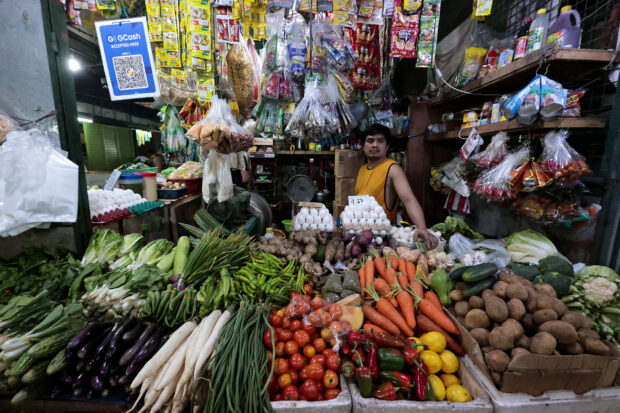 A market vendor watches over his goods as the government reported an unexpectedly good price inflation rate. STORY: March inflation slows but still top concern