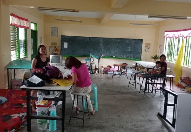 Families from flood-prone areas of Barangay DelRosario in Mercedes, Camarines Norte, stay in classrooms at Mercedes High School on Wednesday as Tropical Depression Amang dumps heavy rains in Bicol region. STORY: Tropical Depression Amang forces evacuation in Bicol