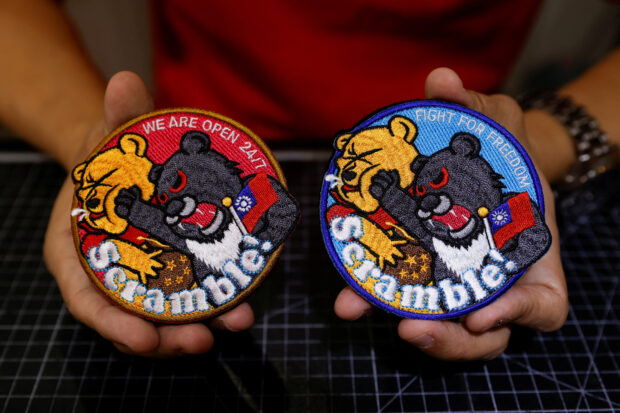 Patches depicting a Formosan black bear holding Taiwan’s flag and punching Winnie the Pooh at a store in Taoyuan
