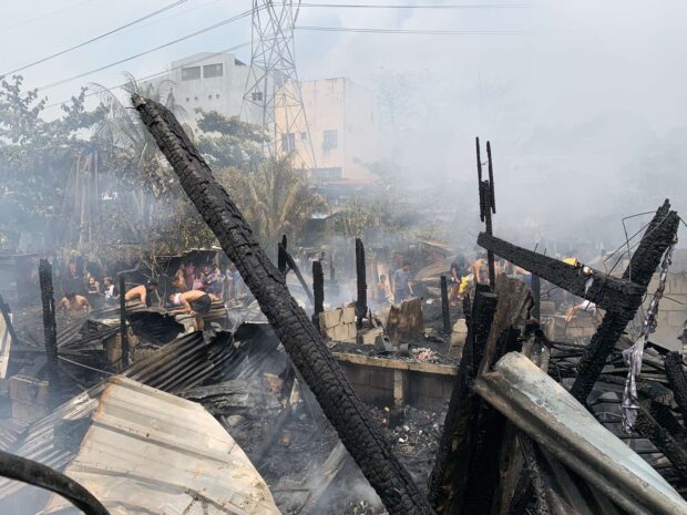 A fire devastates an informal settlers area in Barangay Tatalon in Quezon City on Friday, April 7, 2023.