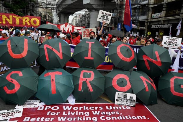 Demonstrators take part in a Labor Day rally in Mendiola, Manila on May 1, 2023. (Photo by JAM STA ROSA / AFP)