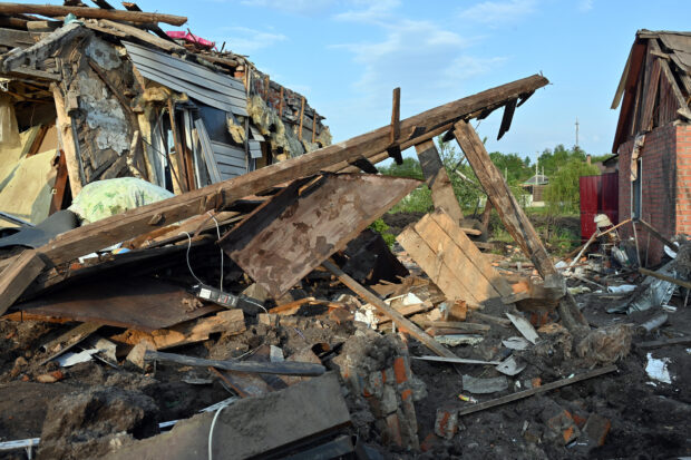A photograph shows a destroyed house after a missile strike in Tsirkuny village, Kharkiv region on May 18, 2023. As a result of the shelling, two private hoses were completely destroyed.  52-year-old local resident was died and two two more local residents were injured. (Photo by SERGEY BOBOK / AFP)