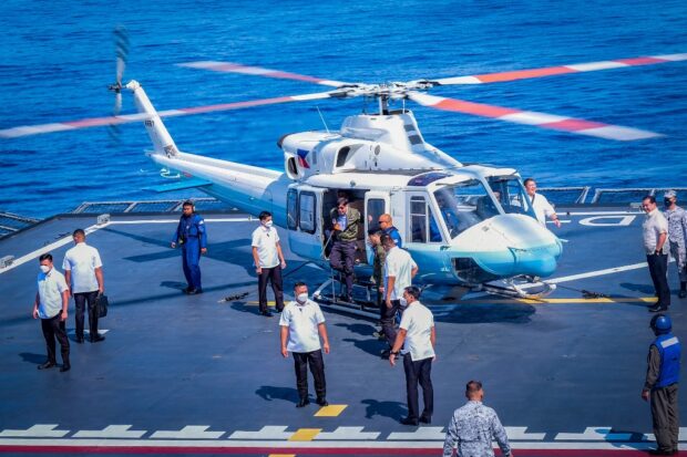Philippine President Ferdinand Marcos Jr. arrives on board the Philippine navy ship BRP Davao del Sur, a Tarlac-class landing platform dock, during the navy's capability demonstration off Zambales, facing the South China Sea on May 19, 2023. (Photo by YUMMIE DINGDING / POOL / AFP)