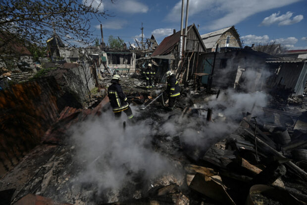 Firefighters work at a site of a residential house destroyed by a Russian military strike, amid Russia's attack on Ukraine, in the village of Malokaterynivka, Zaporizhzhia region, Ukraine May 11, 2023. REUTERS/Stringer
