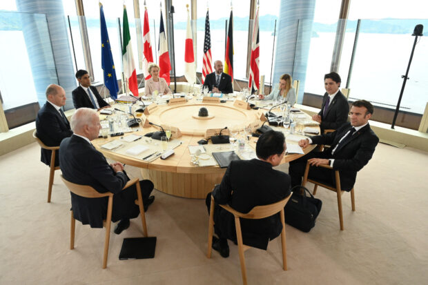 U.S. President Joe Biden, Germany's Chancellor Olaf Scholz, Britain's Prime Minister Rishi Sunak, European Commission President Ursula von der Leyen, President of the European Council Charles Michel, Italy's Prime Minister Giorgia Meloni, Canada's Prime Minister Justin Trudeau, France's President Emmanuel Macron and Japan's Prime Minister Fumio Kishida attend a working lunch meeting at G7 leaders' summit in Hiroshima, western Japan May 19, 2023, in this handout photo released by Ministry of Foreign Affairs of Japan. Ministry of Foreign Affairs of Japan/HANDOUT via REUTERS