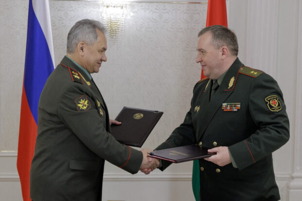 Russian Defence Minister Sergei Shoigu shakes hands with Belarusian Defence Minister Victor Khrenin during a meeting in Minsk, Belarus May 25, 2023. Russian Defence Ministry/Handout via REUTERS