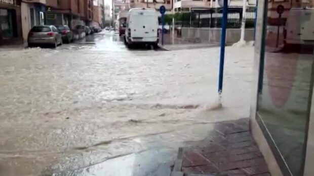 Torrential rain that followed a prolonged drought turned streets into rivers in towns along Spain's Mediterranean coast.
