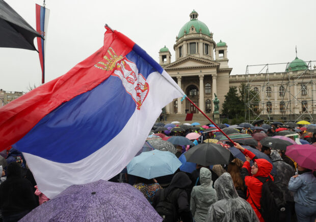 Tens of thousands brave rain and wind in Belgrade in an anti-government protest over two mass shootings that killed 18 people