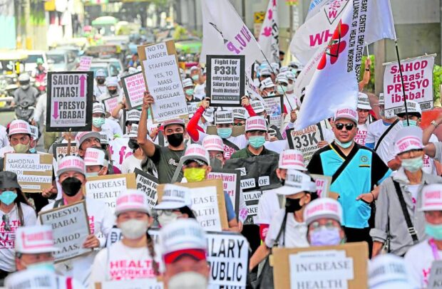 Activists demanding higher pay and more benefits for personnel in public and private hospitals and health institutions mark National Health Workers’ Day with a protest march in Manila on Friday. 