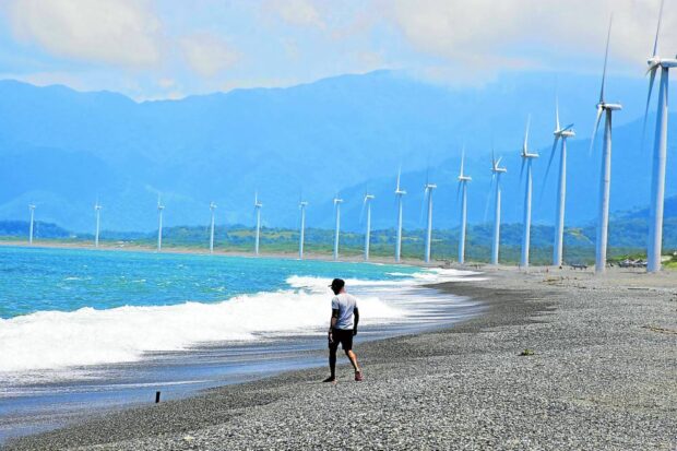 PERFECT BACKDROP The wind farm in Bangui, Ilocos Norte, in this photo taken in 2019, is a picture perfect spot for tourists exploring northern Luzon. Other wind farms also operate in the townsof Burgos and Pagudpud as the country taps renewable energy sources to help lower the cost of electricity. —WILLIE LOMIBAO