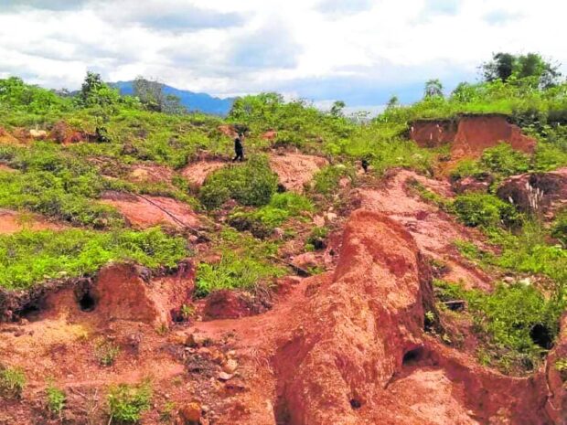 DAMAGED A hill in Barangay Tumpagon, Cagayan de Oro City is heavily damaged by illegal mining operations along the Iponan River as shown in this undated photo. CAGAYAN DE ORO CITY LOCAL ENVIRONMENT AND NATURAL RESOURCES OFFICE PHOTO