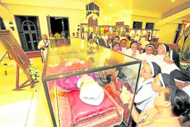 HOLY PLACE Nuns, priests and laypeople venerate a waxsculpture containing the skeletal remains of Archbishop Teofilo Camomot before its entombment in “Domus Teofilo” (House of Teofilo) in Carcar City on Jan. 4, 2018. —CONTRIBUTED PHOTO