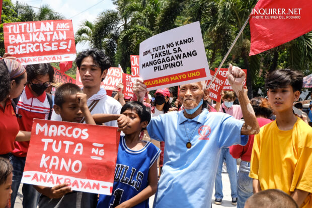 At 74, Elmer Cordero stood in front of the U.S. Embassy in Manila with his fist raised and his placard up high. Despite the unforgiving weather, he still chose to brave the heat and march along the streets on Labor Day, one with his fellow countrymen calling for genuine change.