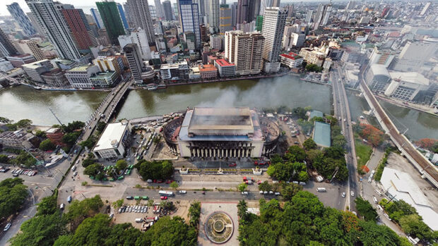 REMNANTS OF A LANDMARK A drone shot taken on Monday afternoon shows smoke billowing from the Manila Central Post Office as firefighters continue to put out the blaze that started on Sunday night. Manila Mayor Honey Lacuna assures heritage advocates that no commercial development will be allowed on the Post Office site, an “institutional zone.” —GRIG C. MONTEGRANDE