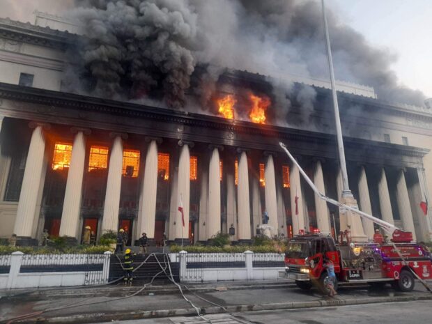 Firefighters control the blaze at the Manila Central Post Office more than seven hours after a fire was confirmed to have started at the building