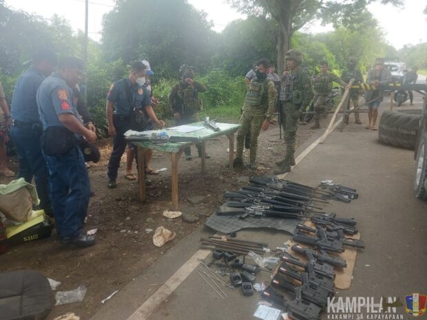 ARMS CACHE. Police and soldiers document the high-powered firearms seized from a suspected gun-runner at a checkpoint in Libungan, Cotabato province Thursday (May 4). (Photo from 6th ID)