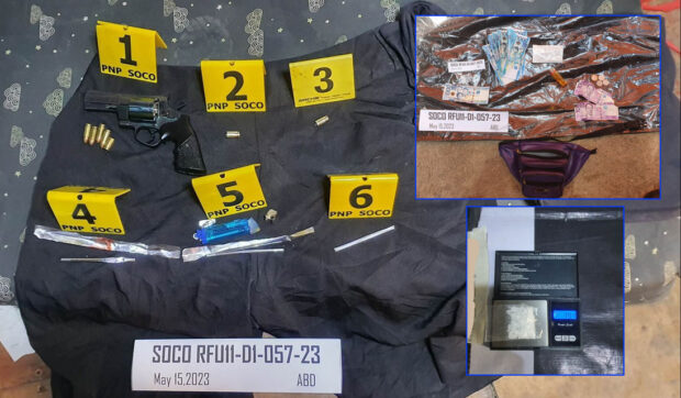 Suspected illegal drugs, a pistol and cash are recovered by police following an anti-drug operation that resulted in the death of an alleged suspect in Barangay 76-A Bucana.