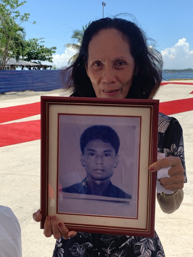 From left: Marilyn Juatno holds a portrait of his brother Sergeant Domingo Deluana.