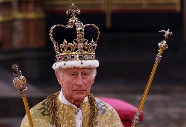 Britain's King Charles III walks wearing St Edward's Crown during the Coronation Ceremony inside Westminster Abbey in central London on May 6, 2023. 