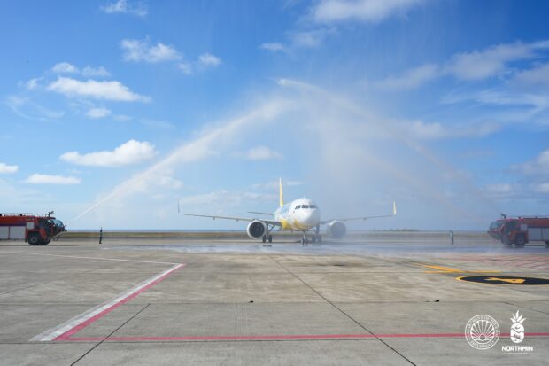 Fire trucks render a water cannon salute to a Cebu Pacific aircraft that landed from Clark International Airport on May 6 during a maiden flight. 