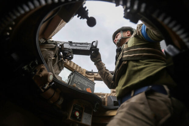 A Ukrainian serviceman mans a machine gun as he rides on a MaxxPro MRAP in the recently liberated village of Blagodatne, Donetsk region on June 16, 2023, amid the Russian invasion of Ukraine. Kyiv's forces are pushing onwards, and even the Russian army confirms that its positions in Urozhaine, another two kilometres south of Blagodatne, have come under attack. The push south in this valley is led by the experienced 68th Jaeger (Hunter) Brigade, and is the most concrete sign of Ukrainian progress since the wider offensive began. (Photo by Anatolii Stepanov / AFP)
