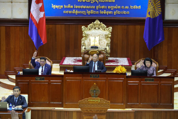 This handout from the Cambodia National Assembly taken and released on June 23, 2023 shows President of the National Assembly Heng Samrin (C), First Vice President of the National Assembly Cheam Yeap (2nd L) and second Vice President of the National Assembly Khuon Sudary (R) vote to pass a law during a meeting at the National Assembly building in Phnom Penh. (Photo by De Ratha / CAMBODIA NATIONAL ASSEMBLY / AFP) / -----EDITORS NOTE --- RESTRICTED TO EDITORIAL USE - MANDATORY CREDIT "AFP PHOTO / CAMBODIA NATIONAL ASSEMBLY / DE RATHA " - NO 