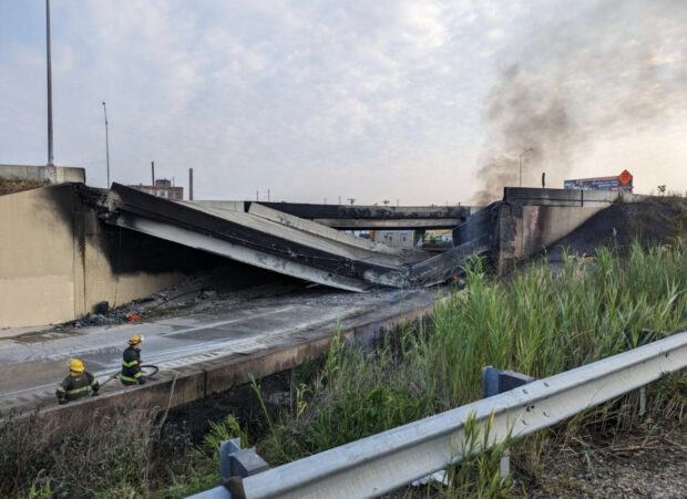 In this handout photo provided by the City of Philadelphia Office of Emergency Management, smoke rises from a collapsed section of the I-95 highway on June 11, 2023 in Philadelphia, Pennsylvania. According to reports, a tanker fire underneath the highway caused the road to collapse.   City of Philadelphia Office of Emergency Management via Getty Images/AFP (Photo by Handout / GETTY IMAGES NORTH AMERICA / Getty Images via AFP)
