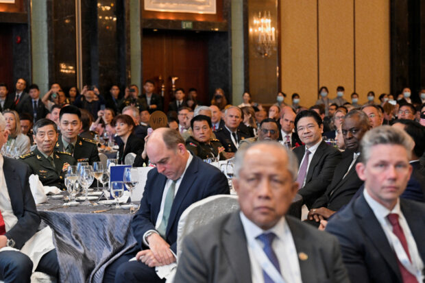 China's Defence Minister Li Shangfu sits at the table with U.S. Secretary of Defense Lloyd J. Austin III and Singapore's Deputy Prime Minister Lawrence Wong during the keynote address at the 20th IISS Shangri-La Dialogue in Singapore June 2, 2023. REUTERS/Caroline Chia
