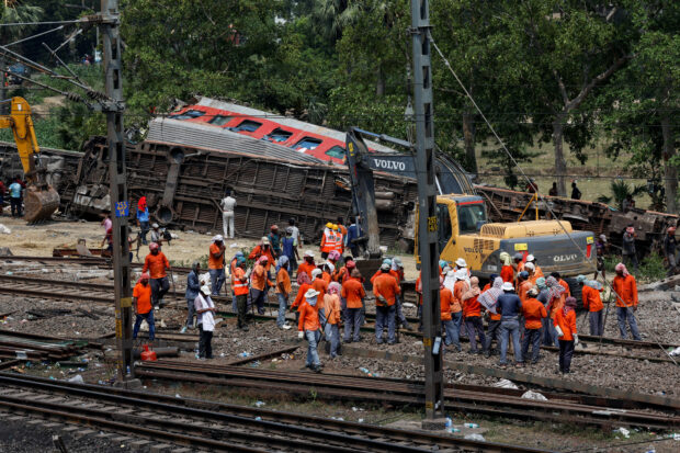Heavy machinery removes damaged coaches from the railway tracks at the site of a train collision following the accident in Balasore district in the eastern state of Odisha, India, June 4, 2023. REUTERS/Adnan Abidi