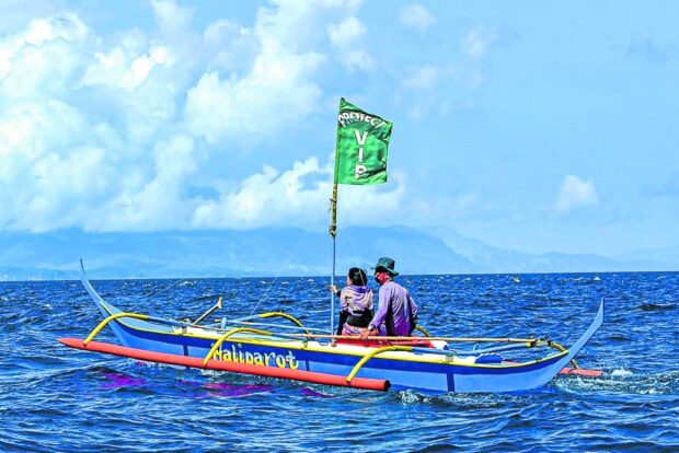 A fishing boat used by protesters sails on the waters of Batangas province in this photo posted on the Facebook page of Center for Energy, Ecology and Development (CEED) on April 22, 2023. STORY: DOE’s fossil gas projects in Batangas alarm green group