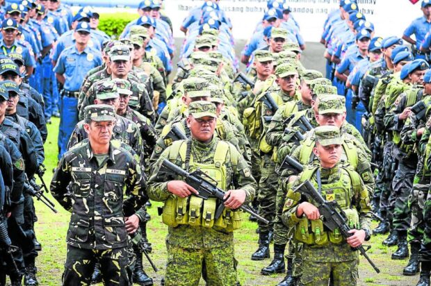 BATTLE READY Military and police personnel stand in formation in this file photo. Their pension system is nowunder review. —INQUIRER FILE PHOTO