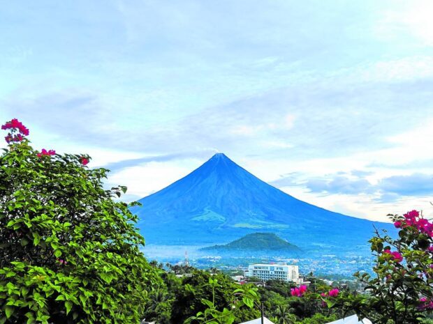 NOW CLEAR Legazpi City residents and visitors get a full view of the perfect conical shape of Mayon Volcano amid clear skies on Tuesday morning. Government volcanologists continue monitoring the volcano, which has been placed under alert level 2 due to its increasing unrest. —JOHN MICHAEL MANJARES/CONTRIBUTOR