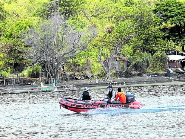 OFF-LIMITS Philippine Coast Guard personnel patrol Taal Lake on June 3 to ensure that no one will enter Taal Volcano Island, or Pulo, in Batangas province, as the volcano shows signs of unrest. Gas emitted by the volcano resulted in the formation of volcanic smog or vog that has reached lakeshore communities. —PHOTO COURTESY OF THE TALISAY MUNICIPAL DISASTER RISK REDUCTION and MANAGEMENT COUNCIL batangas classes vog