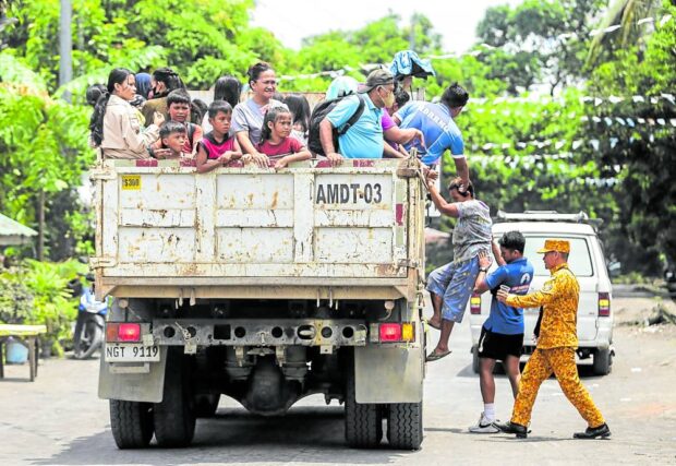 AWAY FROM DANGER ZONE Evacuees are hauled off to shelters from a village in Giunobatan town, Albay, on Friday, a day after the Philippine Institute of Volcanology and Seismology raised the Mayon Volcano alert status to level 3. —MARK ALVIC ESPLANA  