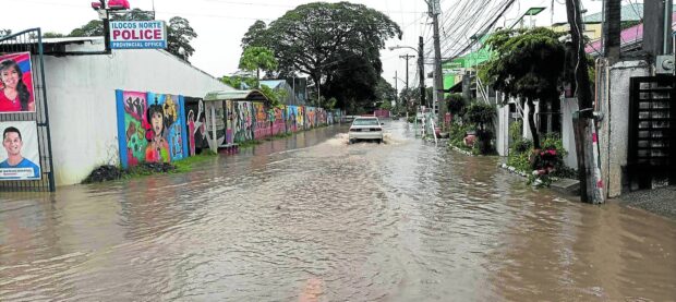 FLOODED STREET A number of streets in Ilocos Norte’s capital Laoag City are flooded on Tuesday due to incessant rain spawned by the southwest monsoon, including this road in front of theprovincial police headquarters. —CONTRIBUTED PHOTO