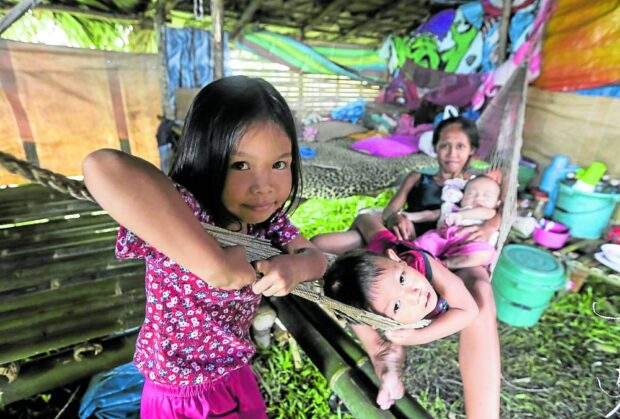 Instead of staying in crowded evacuation sites, evacuees from Mayon’s danger zone, such as this family from Lidong village (right,) shell out money for building huts, like this structure in Salvacion village. STORY: Repeat Mayon evacuees prefer staying in ‘hut city’