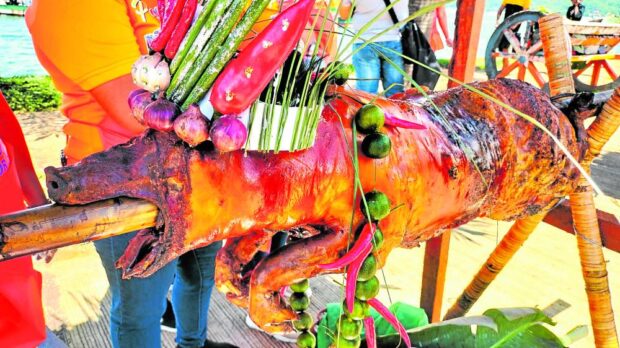 One of the “lechon” (roasted pig) displayed along Baywalk Boulevard in Pagadian City for its third Lechon Festival on June 18, 2023, has a crown made of vegetables as local roasters try to outdo each other to make their roasted pigs attractive. STORY: In Pagadian fest, ‘lechon’ comes in different ways