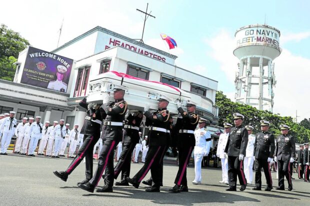 SOMBER HOMECOMING Pallbearers from the Philippine Marine Corps carry the casket of former Sen. Rodolfo Biazon during full military honors given to the formerMarine commandant at the elite unit’s headquarters in Taguig City on Monday. Biazon, 88, who also served as Armed Forces chief of staff, died on June 12. MARIANNE BERMUDEZ