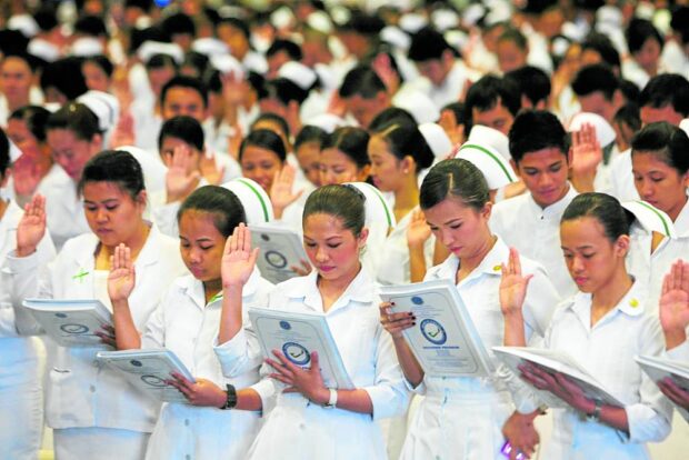 In this file photo, thousands of nursing board passers take their oath as registered nurses at a ceremony held in Pasay City. STORY: Senators reject DOH chief’s plan to hire nursing board flunkers