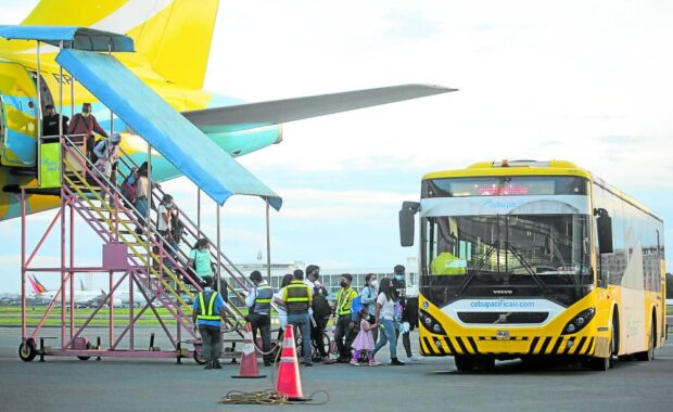 Wednesday’s four-hour Senate hearing chaired by Sen. Nancy Binay unloaded a heap of criticism on Cebu Pacific, whose passengers are seen disembarking in this December 2021 file photo. STORY: Senators confront CebuPac with 3,000 flyer complaints