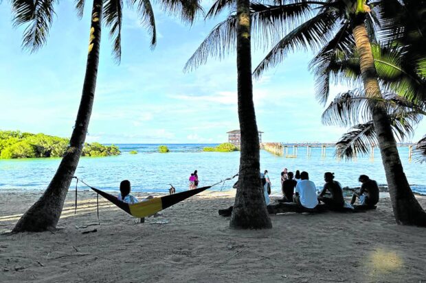 BEACH LIFE Tourists enjoy an afternoon break along the white sand beach in Cloud 9, General Luna town on Siargao Island, the top tourism drawer of Surigao del Norte. —ERWIN MASCARIÑAS
